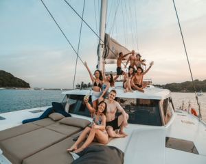 Corporate team building group gathering on the spacious bow of a rental catamaran