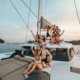 Corporate team building group gathering on the spacious bow of a rental catamaran