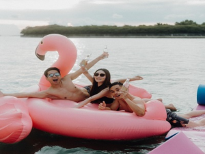 Guests having fun with water sports and inflatables during a Singapore boat charter