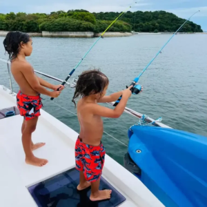 Children enjoying fishing activities during a private island yacht charter excursion