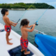 Children enjoying fishing activities during a private island yacht charter excursion